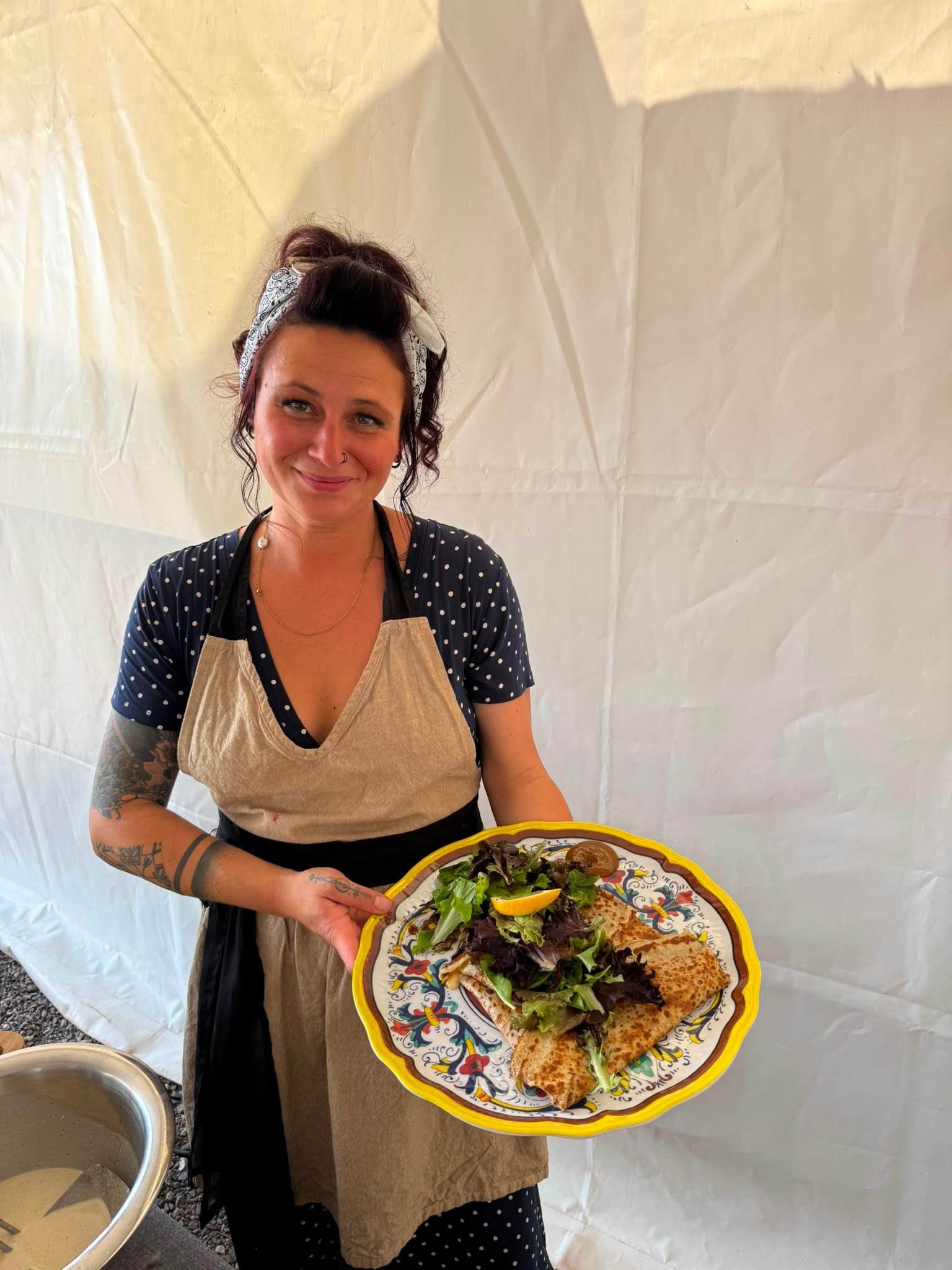 Server presenting a fresh plate of food on the terrace